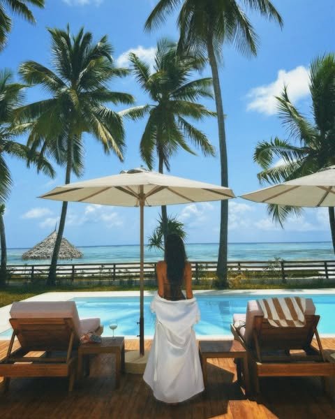 Luxury Coastal Villas - women next to the pool in zanzibar beach